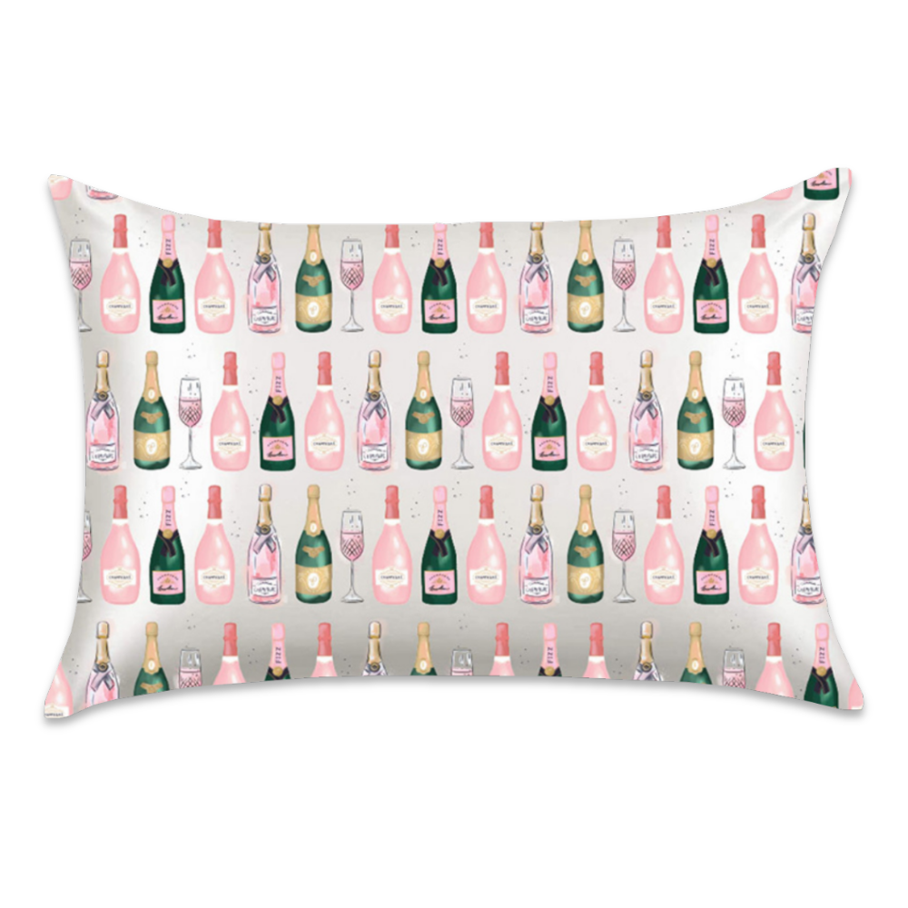 Champagne satin pillowcase featuring pink and green champagne bottles with gold accents and champagne flutes on a white background.