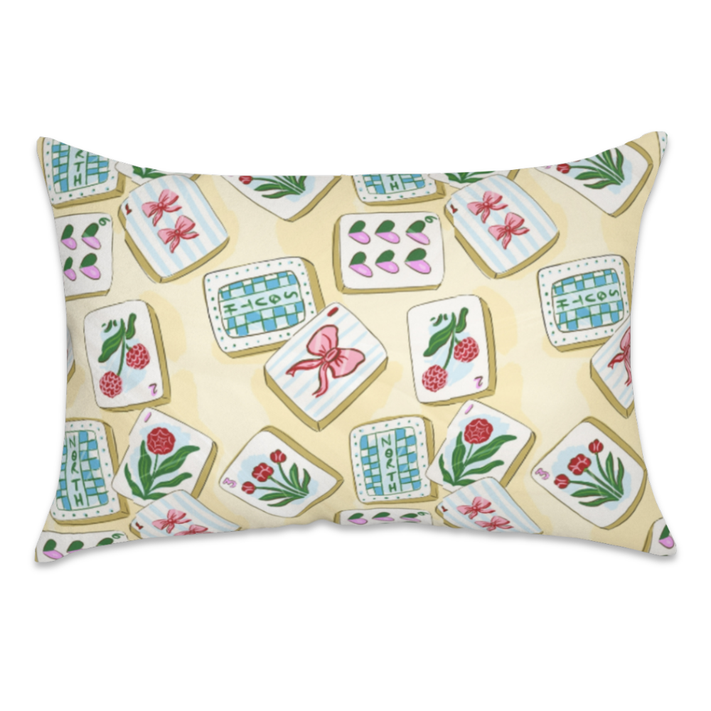 A rectangular decorative pillow featuring a vintage-style mahjong tile pattern on a pale yellow background, isolated on a white studio background.