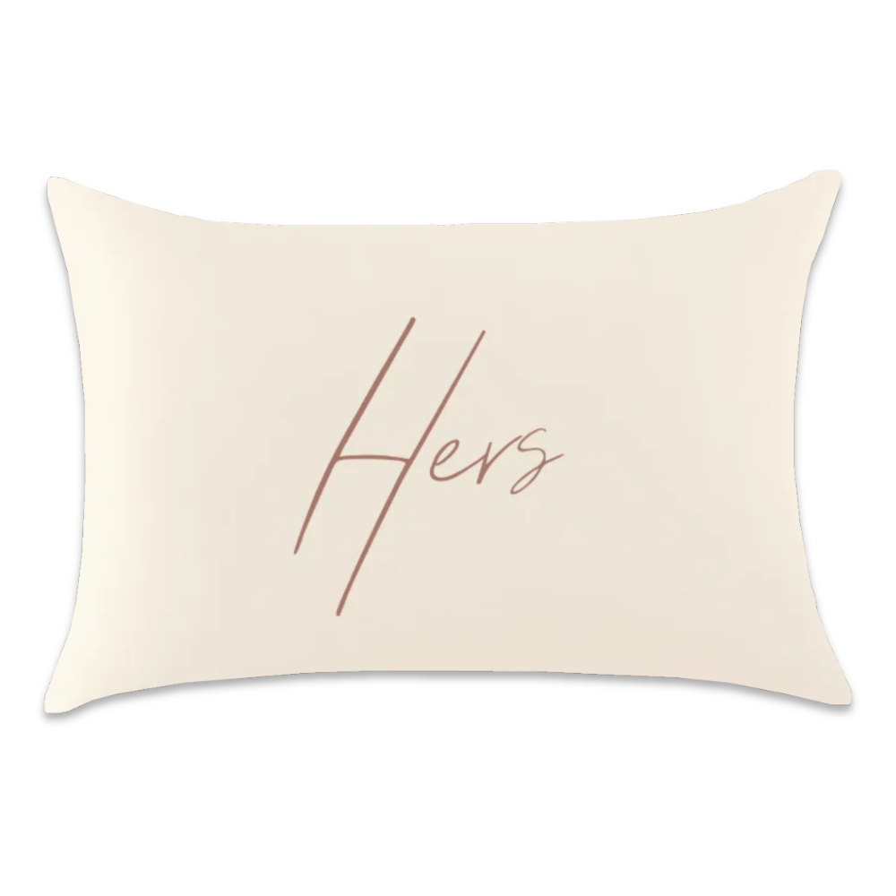 Ivory satin pillowcase with “Hers” written in dusty rose script across the center.