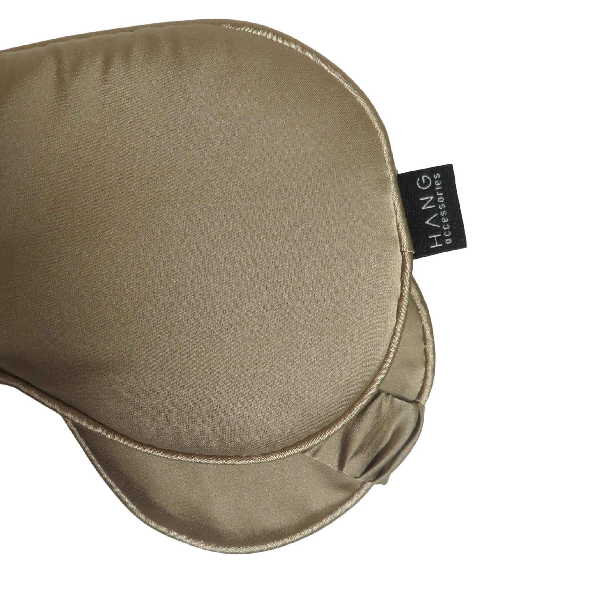Close-up of a satin sleep mask in a warm taupe-beige color.