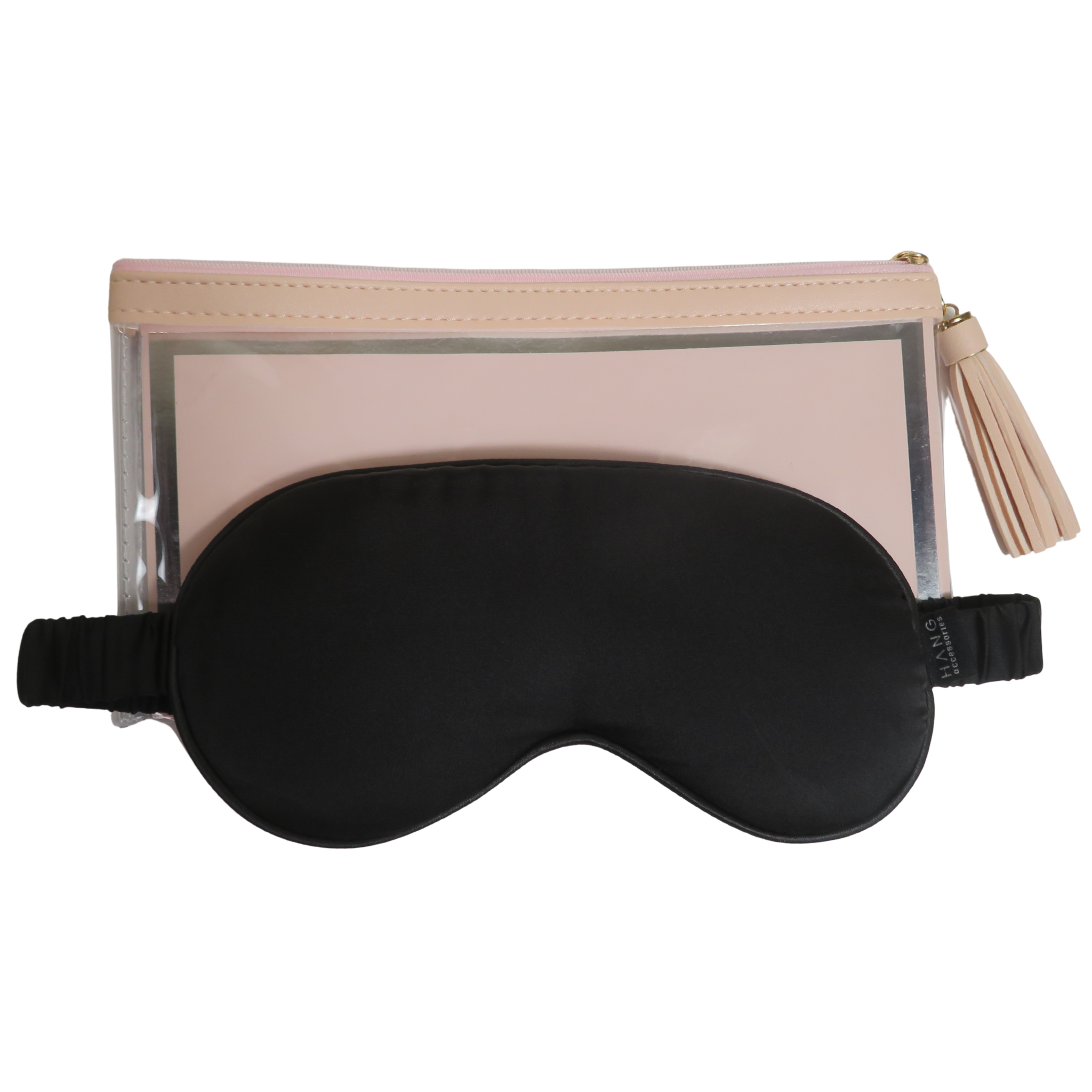 A black sleep mask with an elastic strap placed in front of a blush pink zippered pouch with a clear front panel and a tassel zipper pull, shown on a white background.