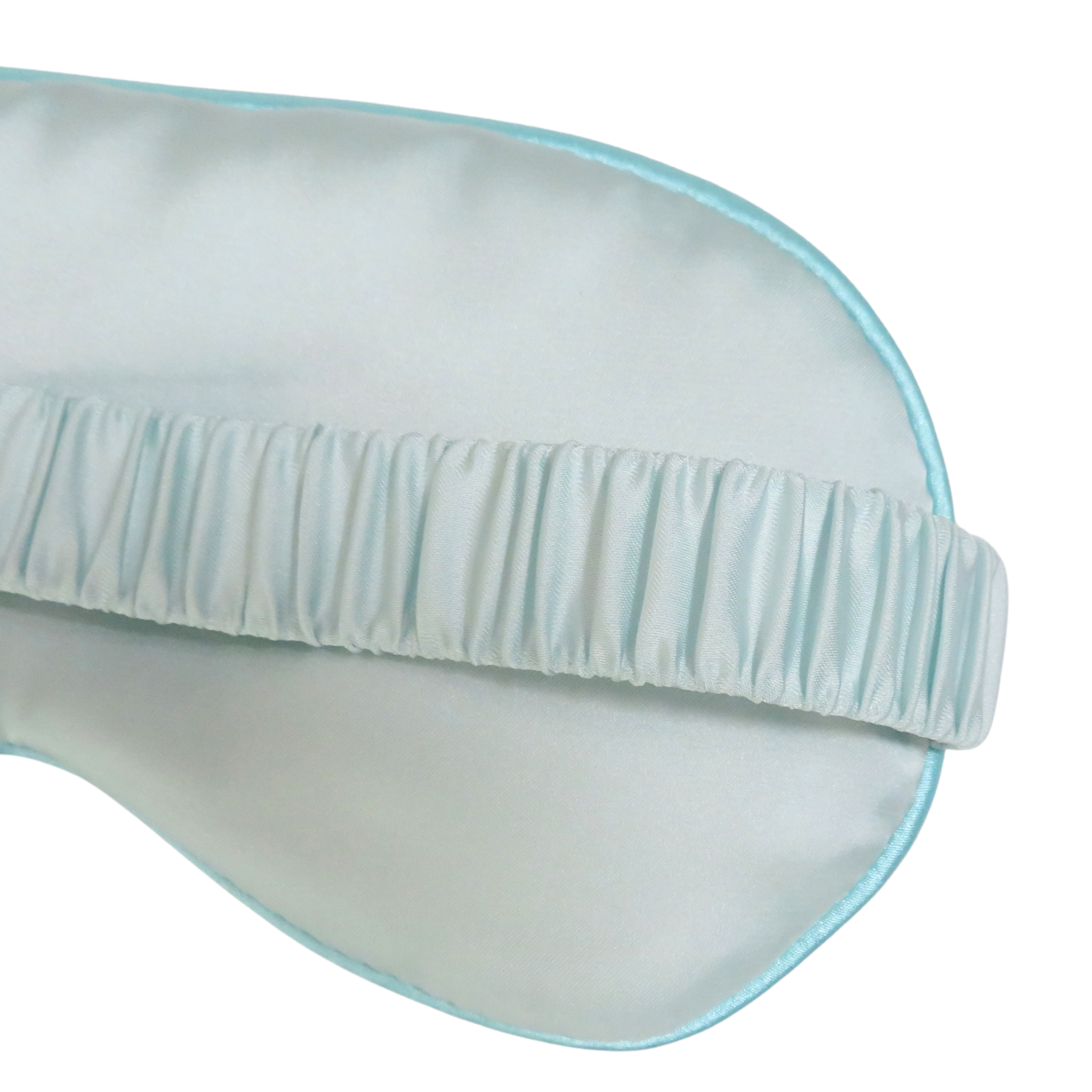A close-up of a light blue satin sleep mask with a matching elasticized eye strap, shown on a plain white background.