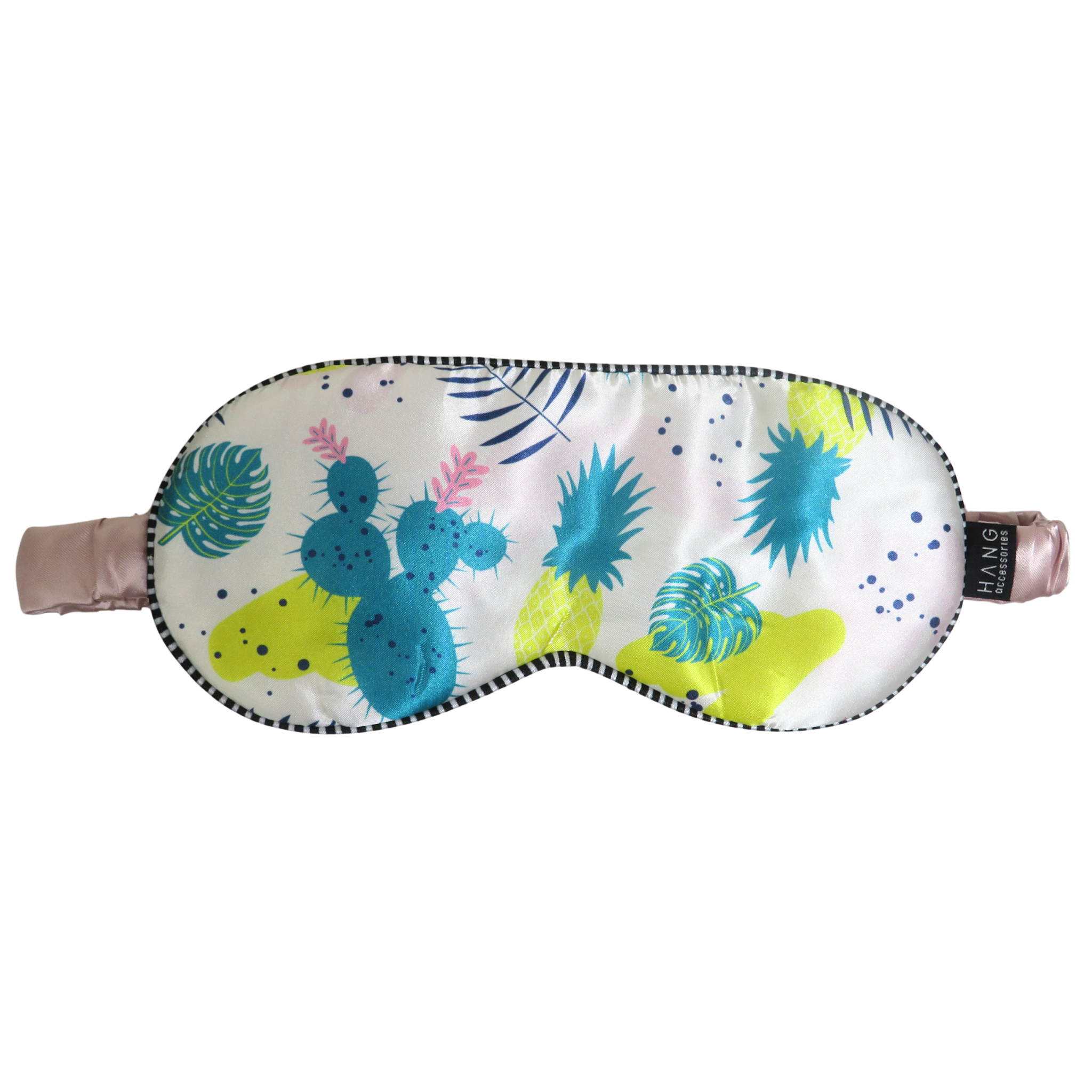 A sleep mask with a colorful tropical cactus, pineapple. and palm leaf print on a white background, featuring a black and white checkered trim and adjustable pink straps.
