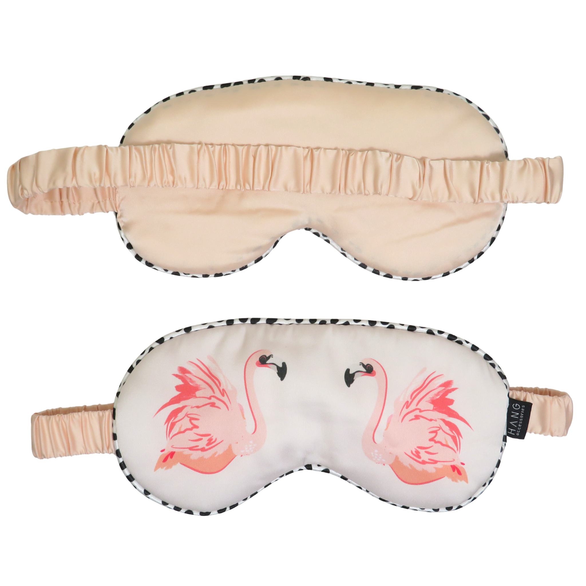 Two sleep masks shown on a plain white background: one in pale blush beige with a black-and-white spotted trim and elastic strap, and one in white with two pink flamingo illustrations and matching black-and-white spotted trim.