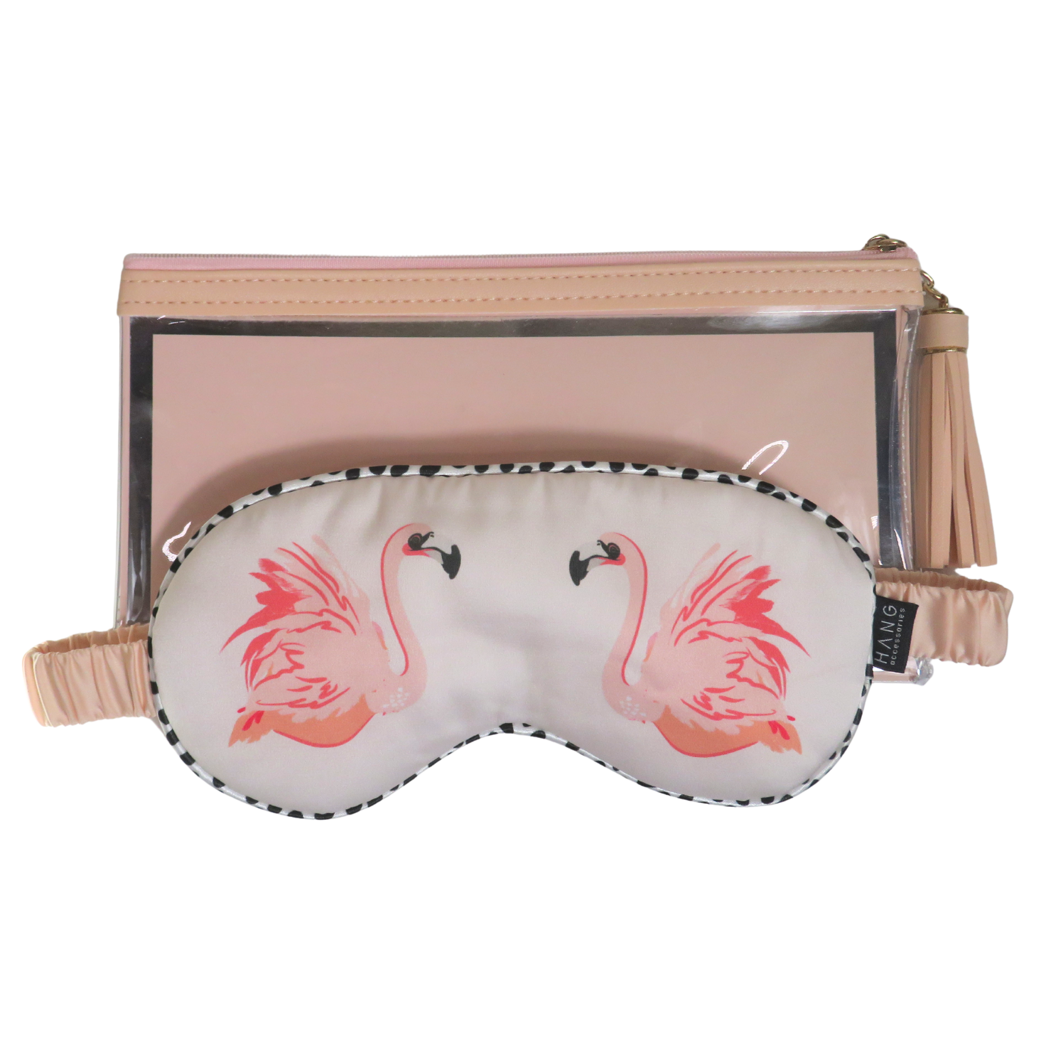 A pink and white travel set featuring a pillowcase with two pink flamingos and a matching eye mask, displayed in front of a beige clutch with a clear window and tassel strap.