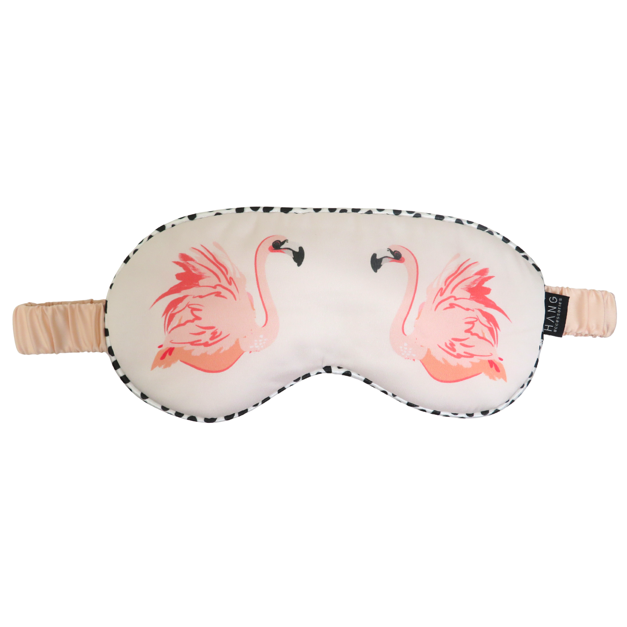 A white sleep mask with a pink flamingo print on each side, featuring a black and white spotted border and a beige elastic strap.