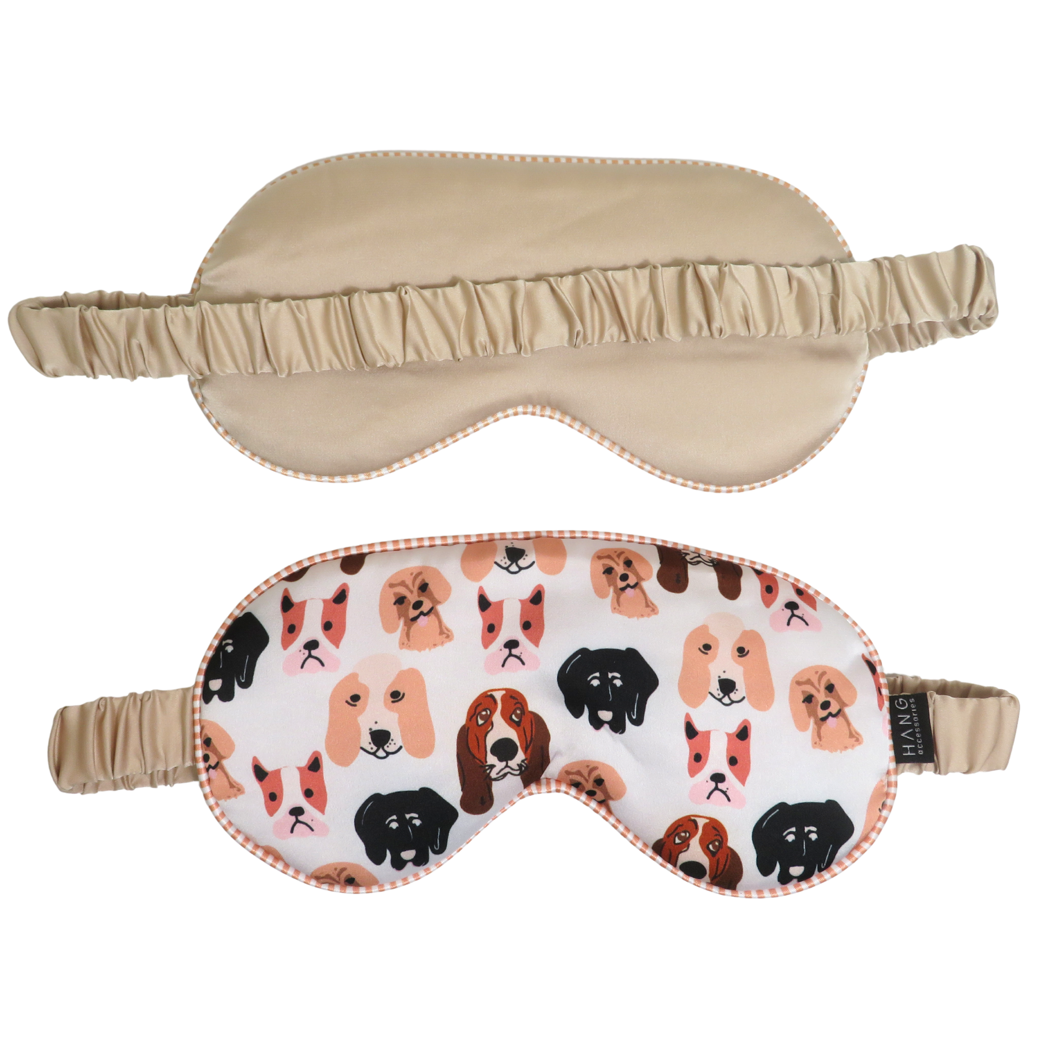 Two sleep masks shown on a white background: one plain beige and one white with a colorful pattern of different dog faces, both with elastic straps.
