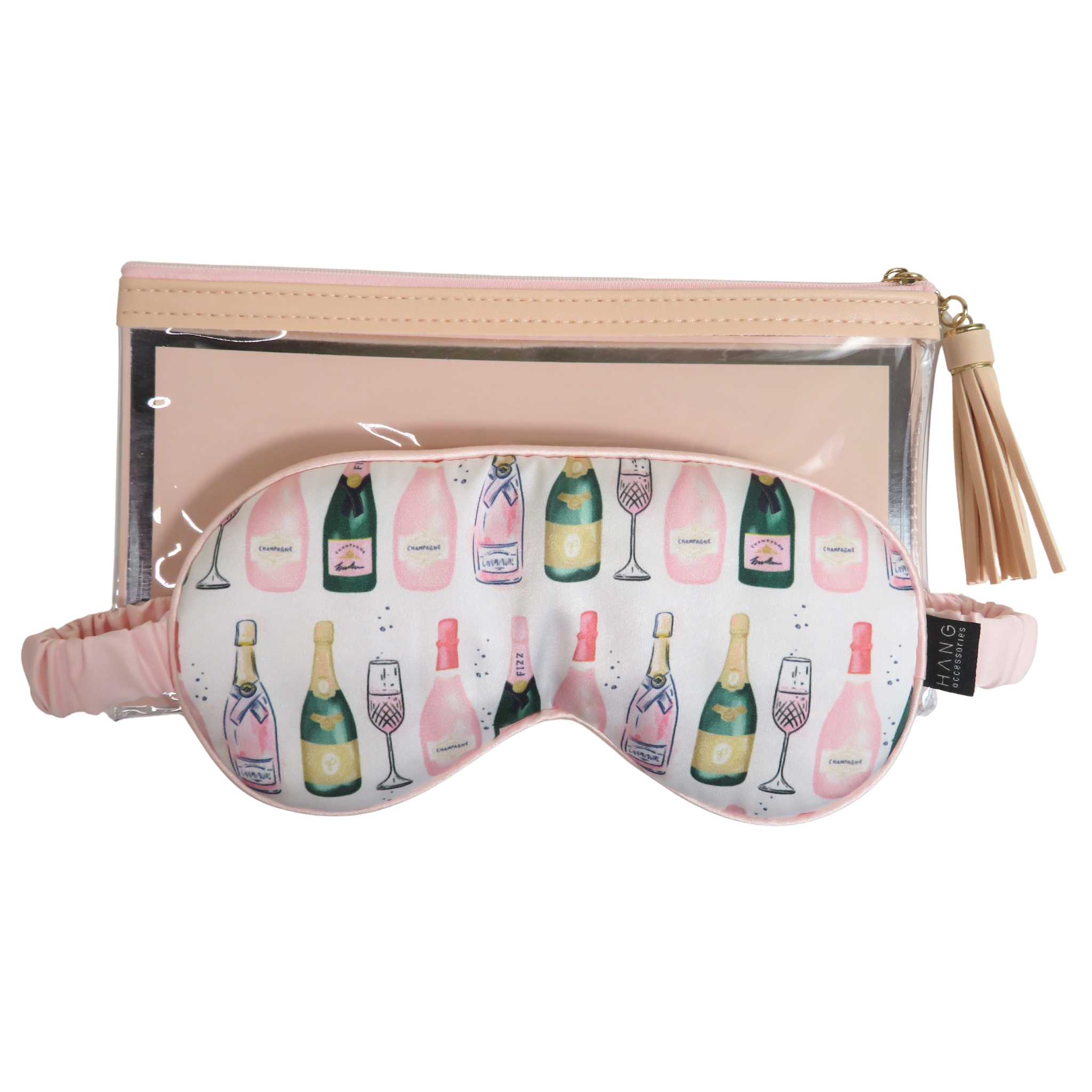 A pink and white champagne-themed sleep mask with a pattern of champagne bottles and glasses, shown in front of a matching translucent pink zippered pouch with a tassel zipper pull.