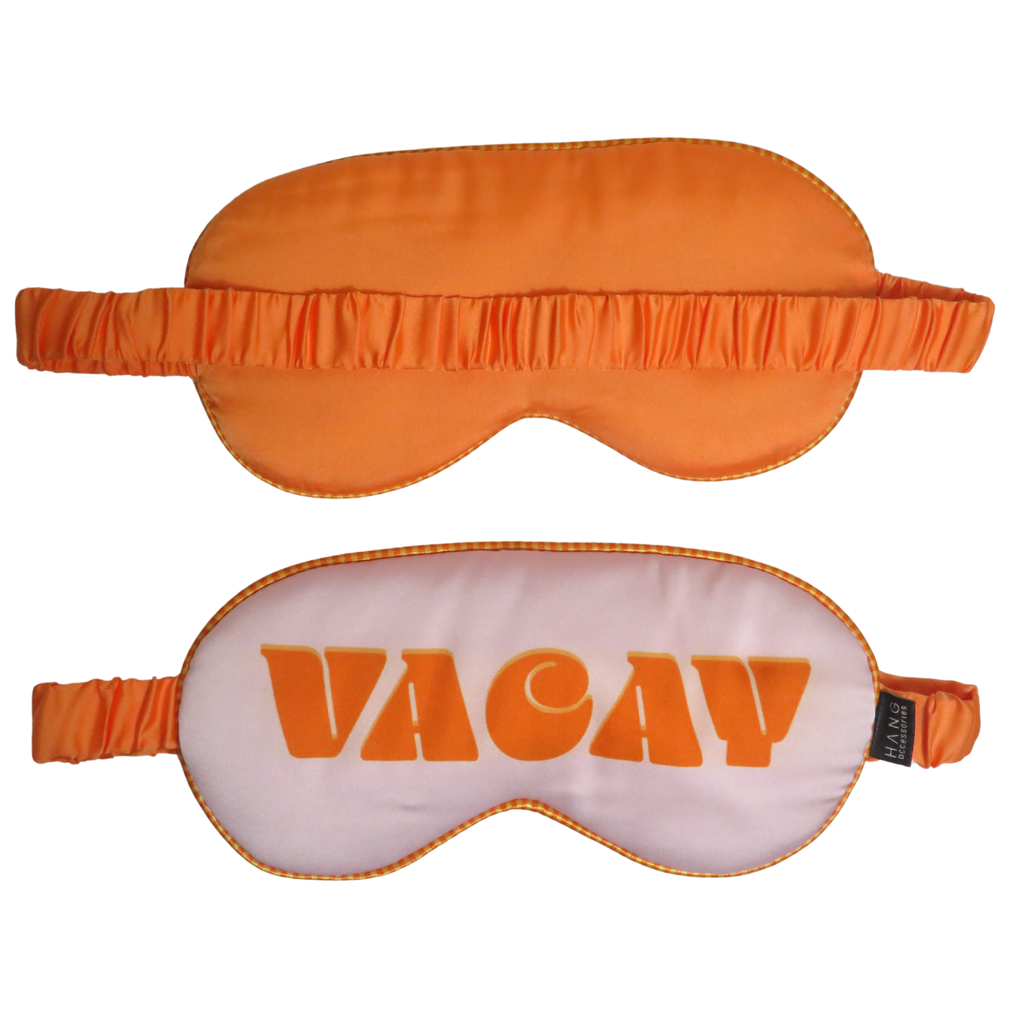 Two sleep masks shown on a plain white background: one solid bright orange mask above, and one white mask below with large orange &