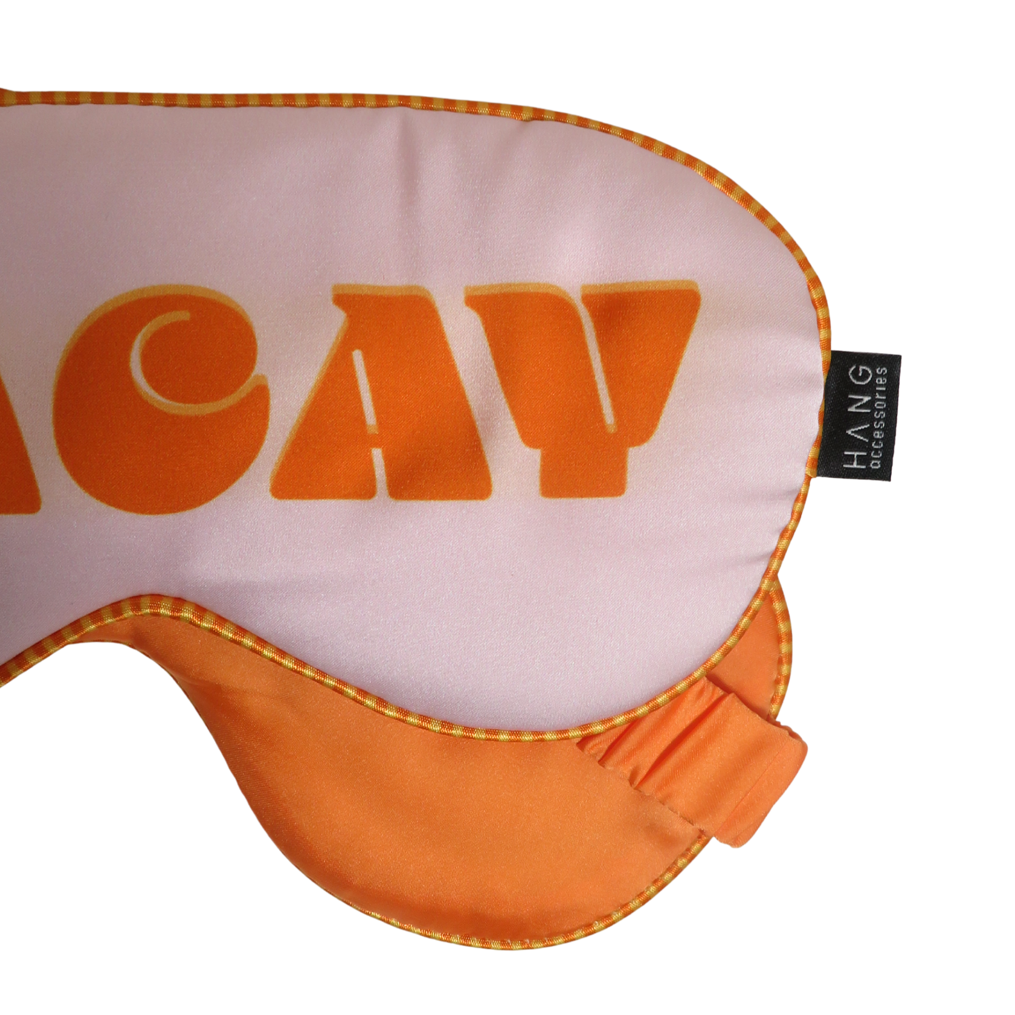 An orange and white sleep mask with the word &