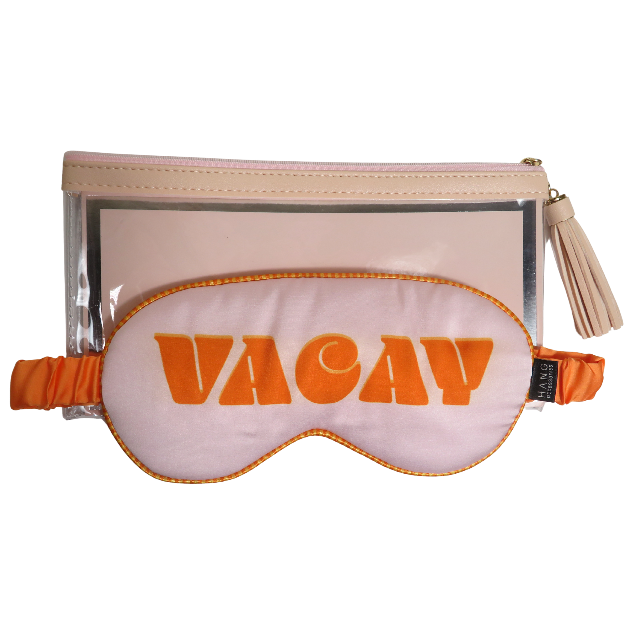 A travel set featuring a light pink sleep mask with orange trim and the word &