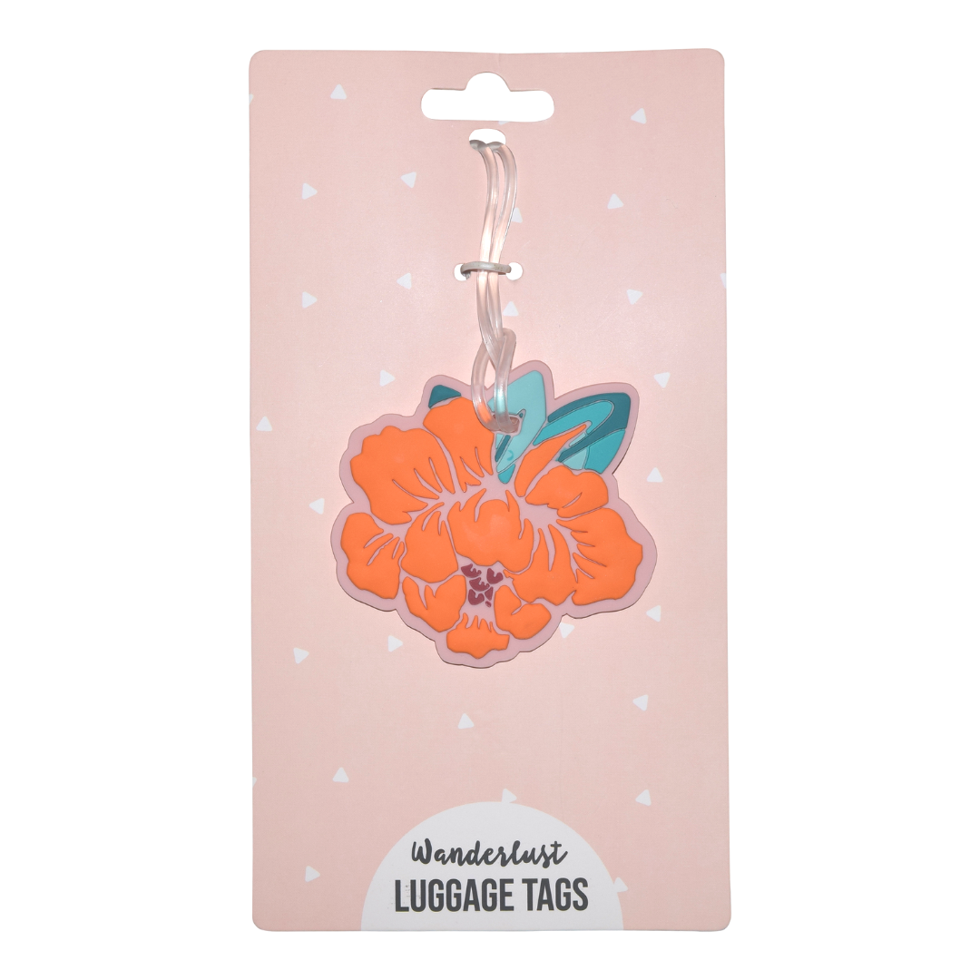 Orange hibiscus silicone luggage tag with teal leaves displayed on Wanderlust retail packaging