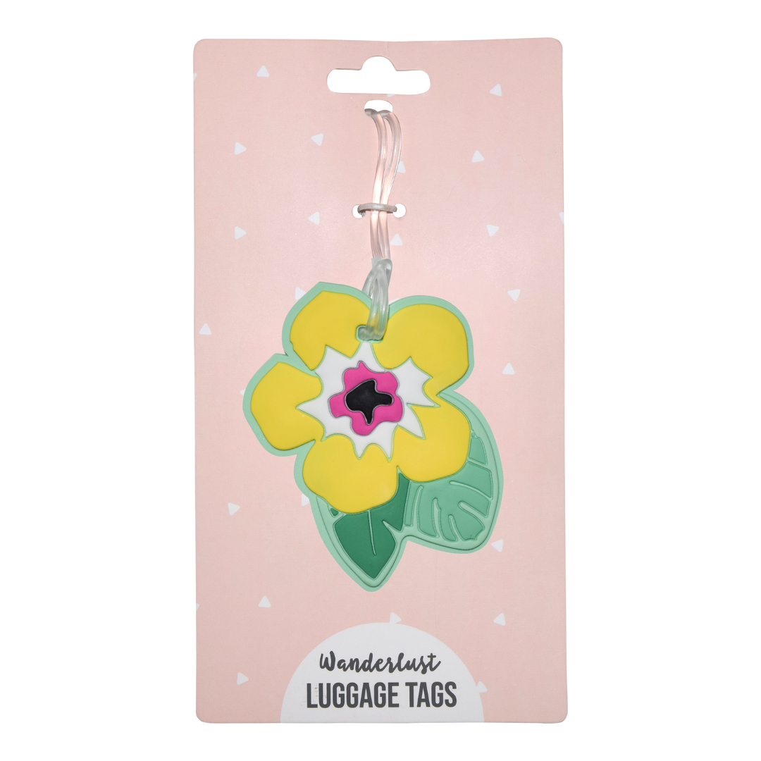 Yellow tropical flower silicone luggage tag displayed on pink Wanderlust retail packaging